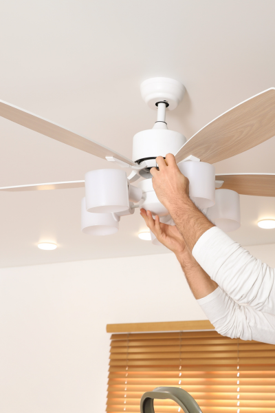 Person installing a ceiling fan