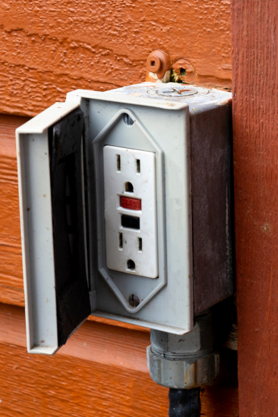 Close-up of a new electrical outlet ready for installation, showing detailed components and screws.