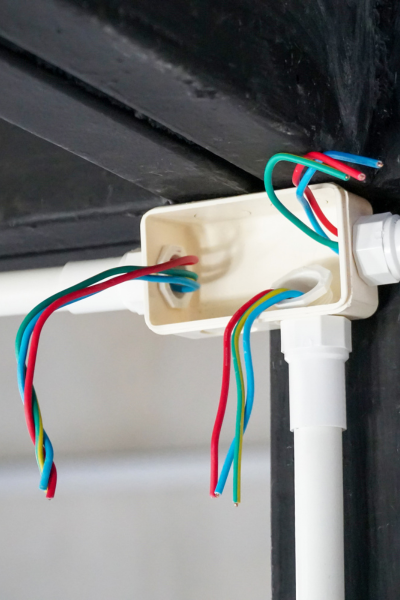 Renovation wiring with exposed electrical wires in a junction box.