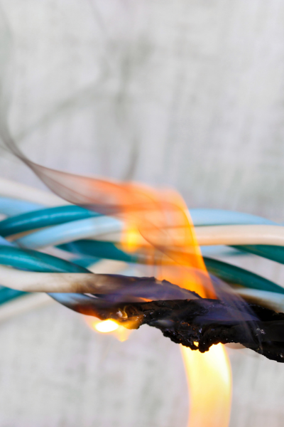 Burning electrical wires due to a short circuit.