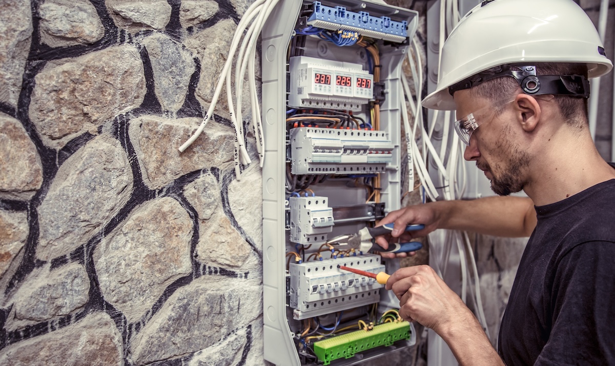 An electrician fixing the home's switchboard in los angeles county